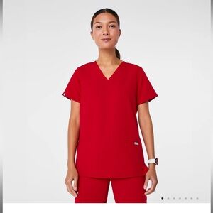 Figs casma three pocket top in winning red. Size XS